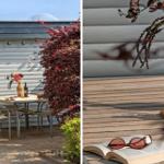 Terrasse mit Tisch, Stühlen und Blumen. Holztisch mit Buch und Sonnenbrille.