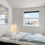 Bedroom with bed, window, and wall art.