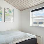 Bedroom with bed, window, and wall art