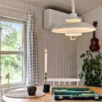 Dining room with table, lamp, and view of garden.