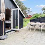 Terrace with table, chairs, and view of garden. Door leads to bedroom.