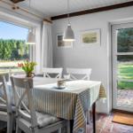 Dining table with chairs, window, and door to outdoor terrace.