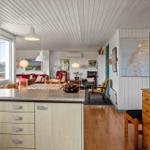 Kitchen with hardwood floor and dining area in the background.