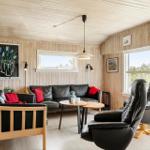 Living room with leather sofa, two chairs, and wood paneling on walls and ceiling.