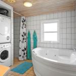 Bath with whirlpool, washing machine, and window.