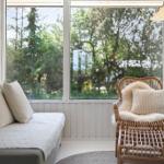 Room with sofa, chair, and large window for view