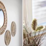 Wand mit runden Spiegeln und dekorativen Elementen. Fenster mit Trockenpflanzen im Vordergrund.