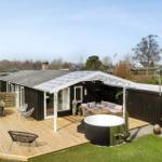 House with terrace, hot tub, and outdoor seating area.