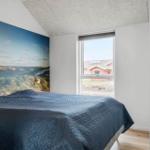 Bedroom with bed, wall mural, and view of red house
