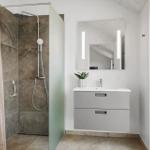 Bathroom with shower, sink, and mirror