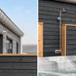 Outdoor shower next to hot tub with wooden frame and dark wood siding.