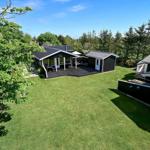 Modern holiday home with terrace and large garden. Surrounded by trees and greenery.
