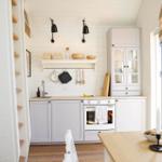 Kitchen with white cabinets, wooden countertop, and built-in oven. Stairs lead upward on the left.