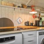 Kitchen with wooden countertop, induction cooktop, dishwasher, and washing machine