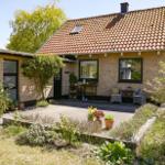 House with terrace, garden, and tiled roof. View of interior and outdoor area.