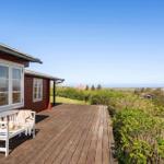 Terrasse mit weißem Stuhl und Blick auf die Landschaft.