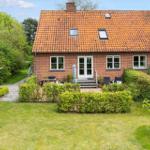 Red brick house with garden, terrace, and skylights.