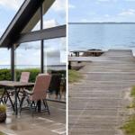 Terrace with table and chairs beside modern house. Wooden pier leads to the water.
