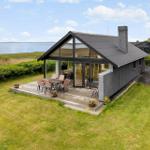 Modern villa with terrace and water view. Garden and barbecue area.
