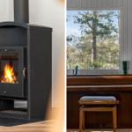 Wood-burning stove with fire and a piano by windows overlooking trees.