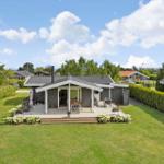 A house with terrace, garden, and view of the sky.