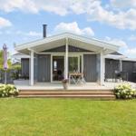 Modern villa with terrace, garden, and seating areas outdoors.