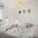 Bedroom with bed, window, and wall art