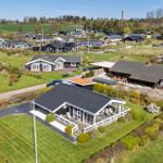 Modern holiday home with terrace and garden. Surrounded by other houses and meadows.