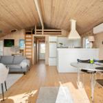 Living area with dining area, kitchen, and sleeping area on upper level.
