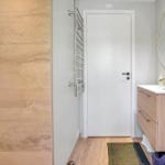 Bathroom with sink, mirror, and heater.