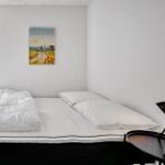 Bedroom with bed, window, and wall art with Denmark.
