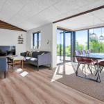Living and dining area with large window view to the terrace.