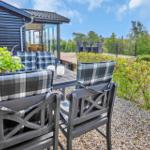 Terrace with seating area and view of garden and house.