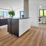 Kitchen with island, living area, and view of the landscape.
