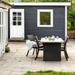Haus mit weißem Zaun, Grill und Glasveranda im Freien.