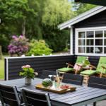 Terrasse mit Tisch, Stühlen und grünen Sesseln. Hintergrund: Haus mit Fenstern und Garten.