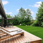 Deck with lounge chairs and grill area in the green.