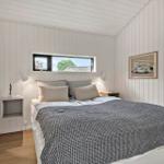 Bedroom with bed, window, and door to terrace.