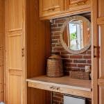 Wooden closet with mirror and basket on work surface