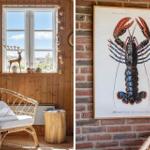 Room with wooden wall, window, and rattan chair. Wall art shows a lobster.