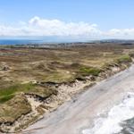 Beach with dunes and ocean view. Holiday home near the water.