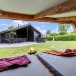 Outdoor area with loungers, fire pit, and view of the villa with terrace.