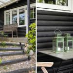 Schwarze Holzhütte mit Terrasse, Sitzbank und grünen Laterne auf Tisch.