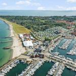 Marina with boats, beach, and vacation rentals near the water.