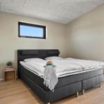Bedroom with double bed, small nightstand, and window. Access to terrace.