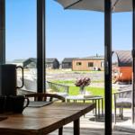Terrace with seating and view of modern wooden houses.