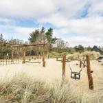 Spielplatz mit Sand, Schaukel und Rutsche in natürlicher Umgebung