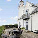 Wohnhaus mit Blick aufs Meer und Leuchtturm. Terrasse mit Tisch, Stühlen und Grill.