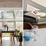 Esszimmer mit Tisch, Stühlen und großem Fenster. Grüner Sitzbank mit Decke und Buch.