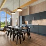 Modern kitchen with dining table and large window view of garden